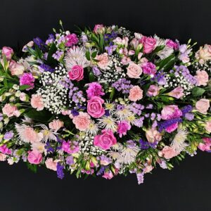 Funeral coffin spray with pink and purple roses