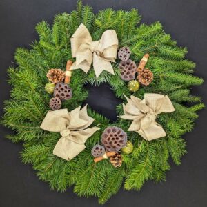 Christmas wreath with greenery, pine cones, and bows