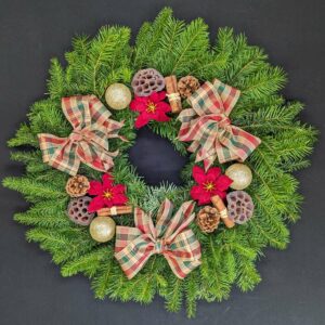 Christmas wreath with bows, pinecones, and poinsettias