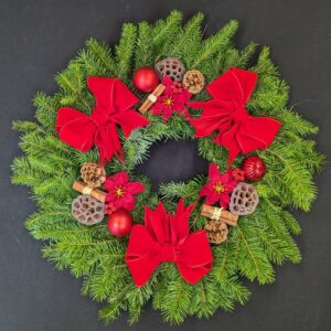 Festive Christmas wreath with red bows and pine cones