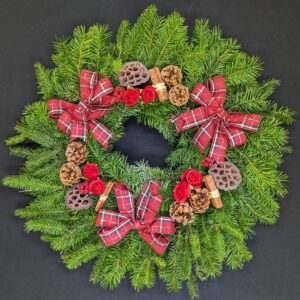 Festive Christmas wreath with red bows and pinecones