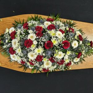 Funeral coffin spray with red carnations and white gerberas