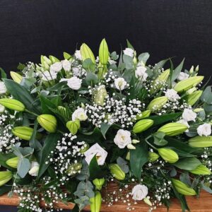 White lily and greenery coffin spray tribute