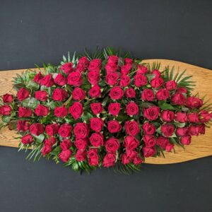 Red rose funeral coffin spray tribute
