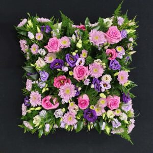 Pink and purple funeral cushion tribute