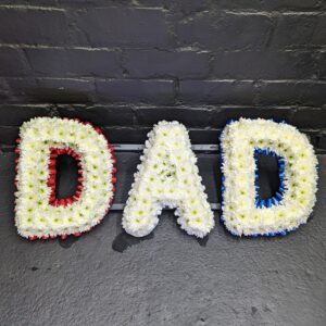 Funeral tribute with letters spelling DAD in flowers