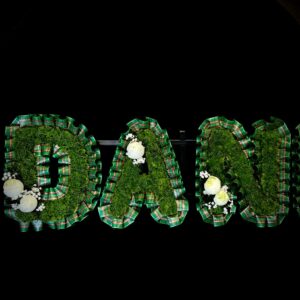 Funeral tribute letters in tartan with foliage