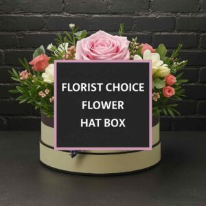 Assorted seasonal flowers in a Florist Choice Hat Box.