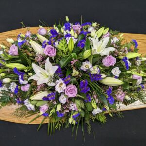 Lavender rose and white lily funeral coffin spray