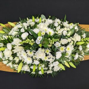 Elegant white lily and rose funeral coffin spray tribute