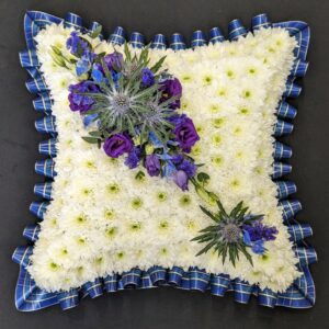 White and blue floral funeral cushion tribute