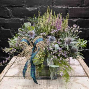Heather, thistles, and foliage bouquet evoking Scottish hills