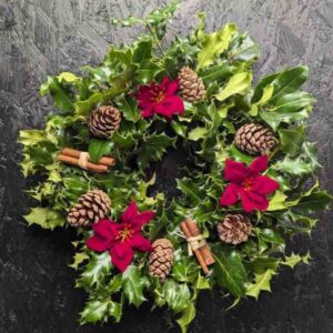 Holly Wreath Traditional fresh Holly Christmas Wreath with pine cone and festive red ribbons