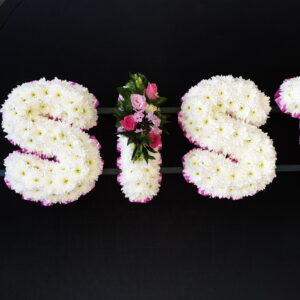 Funeral letters spell out 'SIS' with white and pink flowers