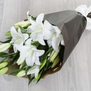 Elegant bouquet of Lunar Lilys in soft white wrapping.