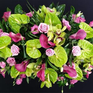 Pink calla lilies, green anthuriums, roses funeral spray
