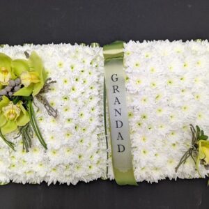 Funeral Open Book tribute with white flowers and ribbon