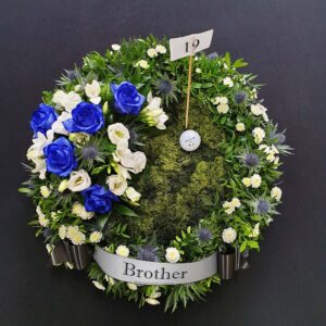 Golf funeral Flowers with blue and white blooms and Golf Ball