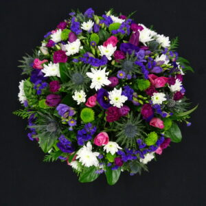 Elegant funeral posy with white, purple, and green flowers
