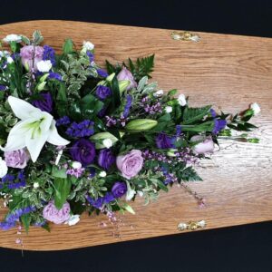 Elegant funeral spray with lilies and roses