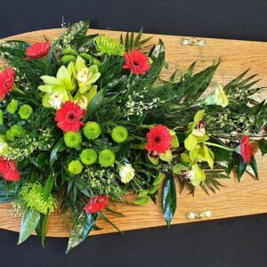 Funeral single ended spray with red gerberas and orchids.