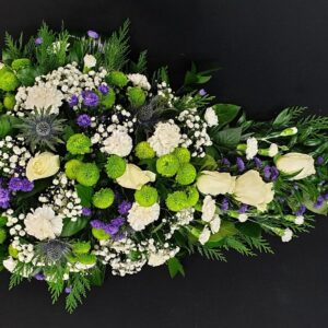 Elegant funeral spray with white roses and green accents