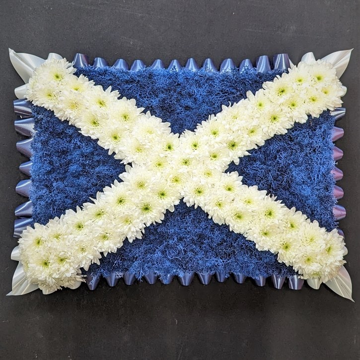 Scottish Flag Scottish flag floral tribute with white cross and blue background.