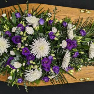Funeral floral spray with purple and white flowers