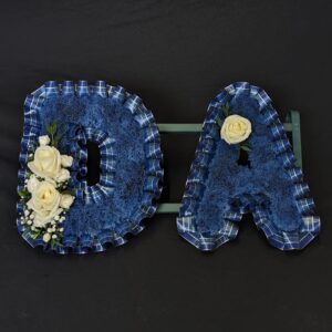 Blue tartan funeral letters with white roses and foliage