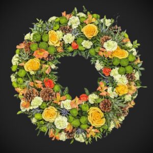 Funeral flower wreath with yellow roses and greenery