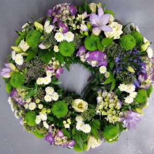 Elegant funeral flower wreath with a blend of Flowers.