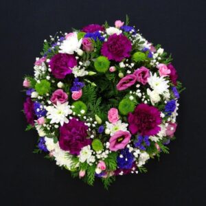 Vibrant funeral flower wreath with assorted flowers