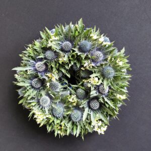 Thistle and greenery funeral wreath tribute