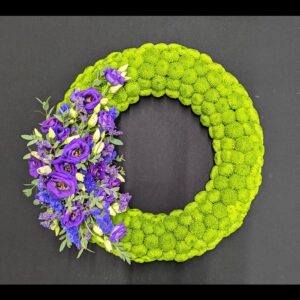 Purple and green floral funeral wreath tribute