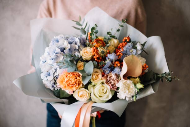 A person holding a personalized flower bouquet